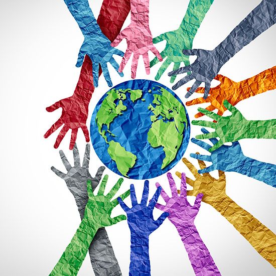 Colored hands surrounding the earth on white background